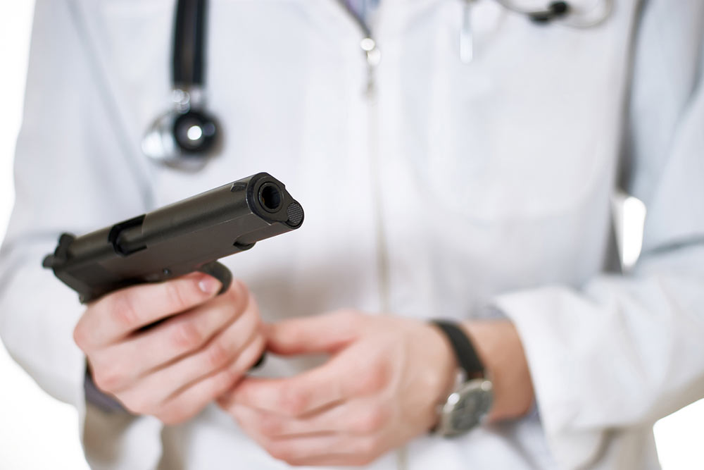Medical professional holding a gun