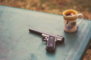 Pistol beside a cup of tea